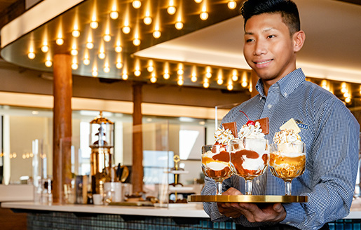 Waiter serves Ghiradelli Hot Fudge Sundae (Photo)
