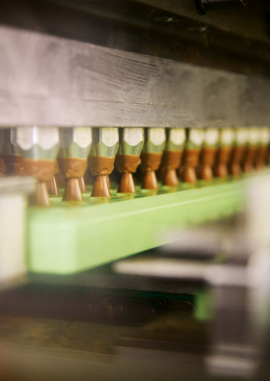 LINDOR truffles poured in form by the pouring machine (Photo)
